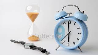 Hourglass displays sand flowing down, while a blue alarm clock shows six o'clock alongside