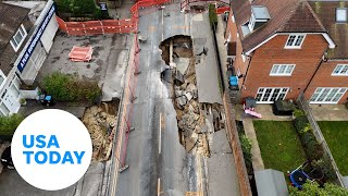 Aerial video shows huge sinkhole in English village | USA TODAY