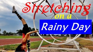 Outdoor stretching on a rainy day. Splits. Workout. Exercises for flexibility. Iron frame