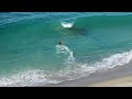 Professional Skimboarders Catching Waves Breaking Off A Rock - Raw Footage