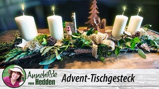 Adventsgesteck aus Naturmaterialien - Längliches Advent -Gesteck mit Kerzen.