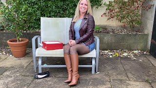 Reviewing brown knee high leather stiletto boots matched with black Wolford tights and denim skirt