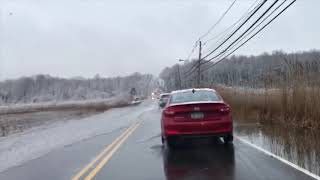 Drivers maneuver around flooding on Staten Island's Travis Avenue