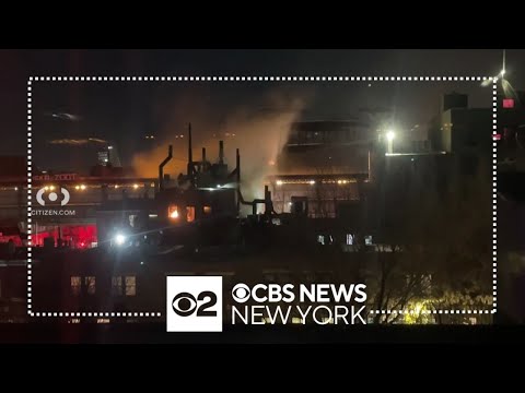 Firefighters battle building fire near train tracks in Brooklyn
