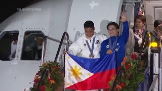 Two-time gold medallist Carlos Yulo among Filipino Olympians given warm welcome home from Paris