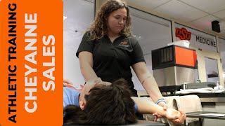 OSU-CHS Athletic Training student Cheyann Sales works with Cowboy Wrestling