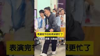 在抖音美好奇妙夜的后台，周深表演完节目后被粉丝团团围住，与小朋友合影、与粉丝打招呼