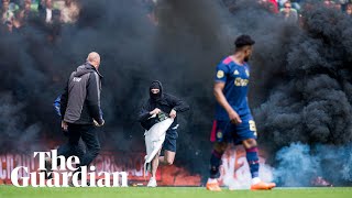 Ajax game suspended as Groningen fans invade pitch to protest relegation