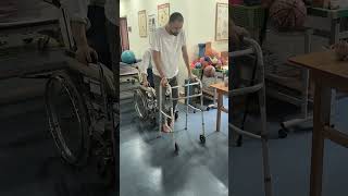 #als patient after receiving stem cell treatment he can walk with the help of a walker