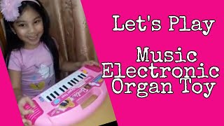 Jashy is having fun playing her Music Electronic Organ Toy