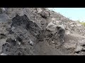 large rock attached to cliff wall finally collapses and breaks into three.