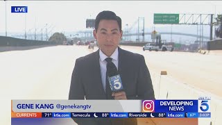 Workers clearing burned-out semi from San Pedro freeway