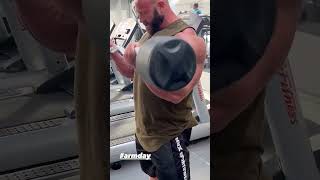 Bald and bearded muscle god Petar Klancir working on his massive biceps