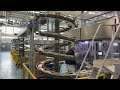 AmbaFlex Spiral Conveyors - SpiralVeyor SVs transporting packs of coffee cups