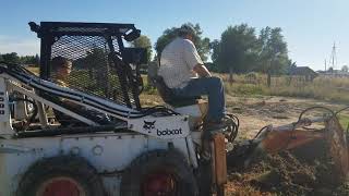 trenching with the Bobcat M500 Skidsteer and backhoe