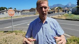 Stopping motorists, who ignored the stop street sign.