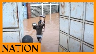 Residents of Supa Care Apartment, Ruaka, salvage belongings after rain water floods their homes