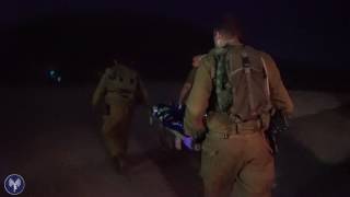 Israeli soldiers treating wounded Syrians