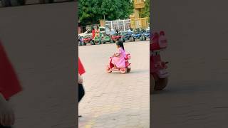 The adorable girl is riding a pink toy motorcycle.#shortvideo #shorts #short #toycar #toys #car