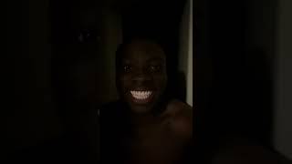 Black man laughing in the dark