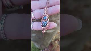 Owyhee Opal with a Grey Blue Flash Moonstone, designed in copper with 2 tiny sterling bead accents.