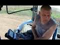 pretty girl learns to drive a tractor. work in the field spring plowing straw baling