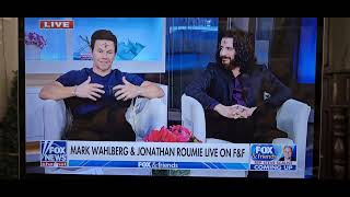 Jonathan Roumie & Mark Walberg pray during interview on Fox and Friends