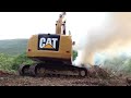 cat 316e l excavator burning brush and moving trees