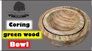 woodturning  coring and rough turning a large green bowl.