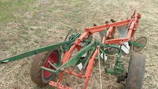 Case L tractor plowing with 3 bottom plow