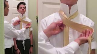 How to tie a tie on someone else.