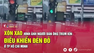 Xôn xao hình ảnh người đàn ông trùm kín điều khiển đèn đỏ ở TP Hồ Chí Minh