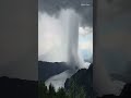 explosion of a rain cloud over lake milstatt in austria . real nature