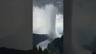 Explosion of a rain cloud over lake Milstatt in Austria . Real Nature