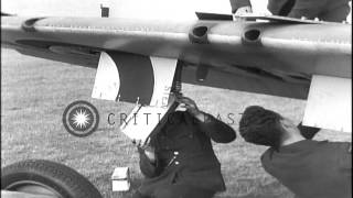 RAF ground crew rearms a spitfire aircraft. View of battle-damaged tail on spitfi...HD Stock Footage