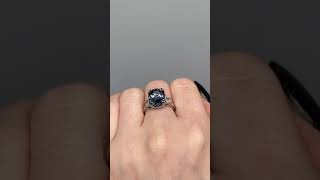 Unheated color change sapphire ring on finger in sunlight