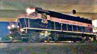 Pink FEC GP40-2 leads a train across the Stuart bridge.