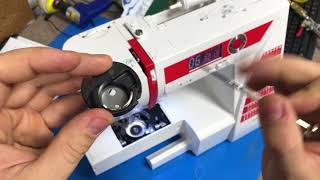 Adjusting tension on a drop in bobbin sewing machine bobbin case