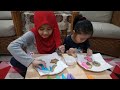 Amani and Arissa Playing Decorate Cookies With Icing