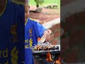 poor 2 years boy grill snails for food on the hot stone grilled food cooking