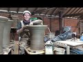 gabriel nichols throwing a medium flower pot using wild clay.