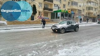 Ice Ice Baku: cars and buses negotiate ice covered road in Azerbaijan