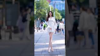 Pretty lady with long legs dancing on the street #194