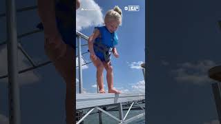 Little girl overcomes fear of jumping into lake