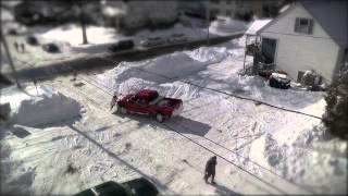 Time-lapse of a plow truck cleaning up snow after a blizzard in Maine