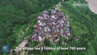 Breathtaking! Watch Chinese village built on single gigantic boulder