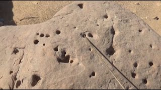 Exaggerated grooves on the same rock, two adjacent tombs