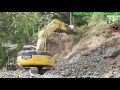 excavator working on river komatsu pc228 cat 320d