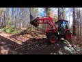 clearing forest trails with a mini excavator and tractor