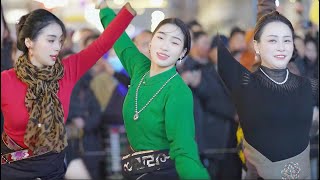 beautiful Tibetan women gather together to dance happily